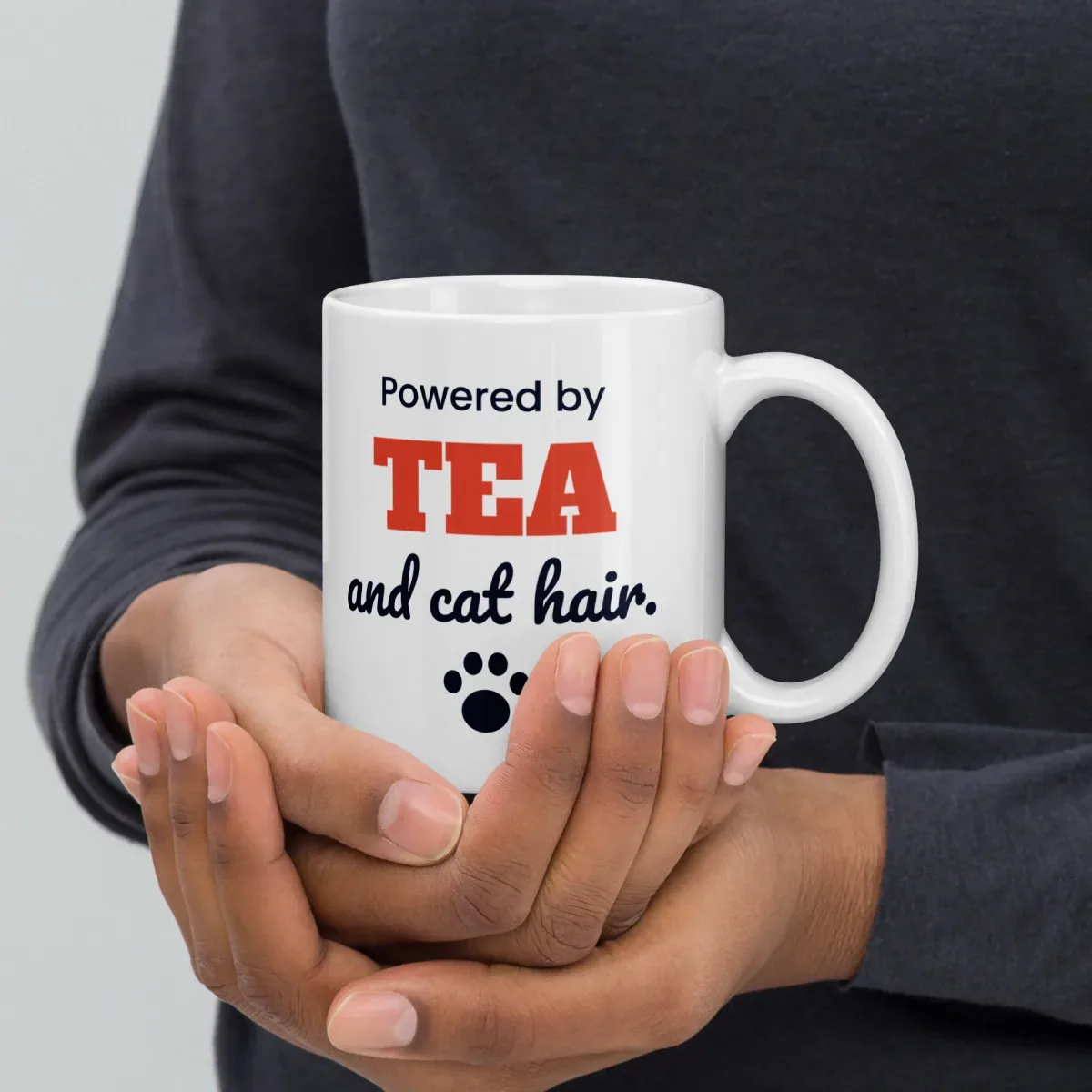 Powered by tea and cat hair — 11oz mug: In hand