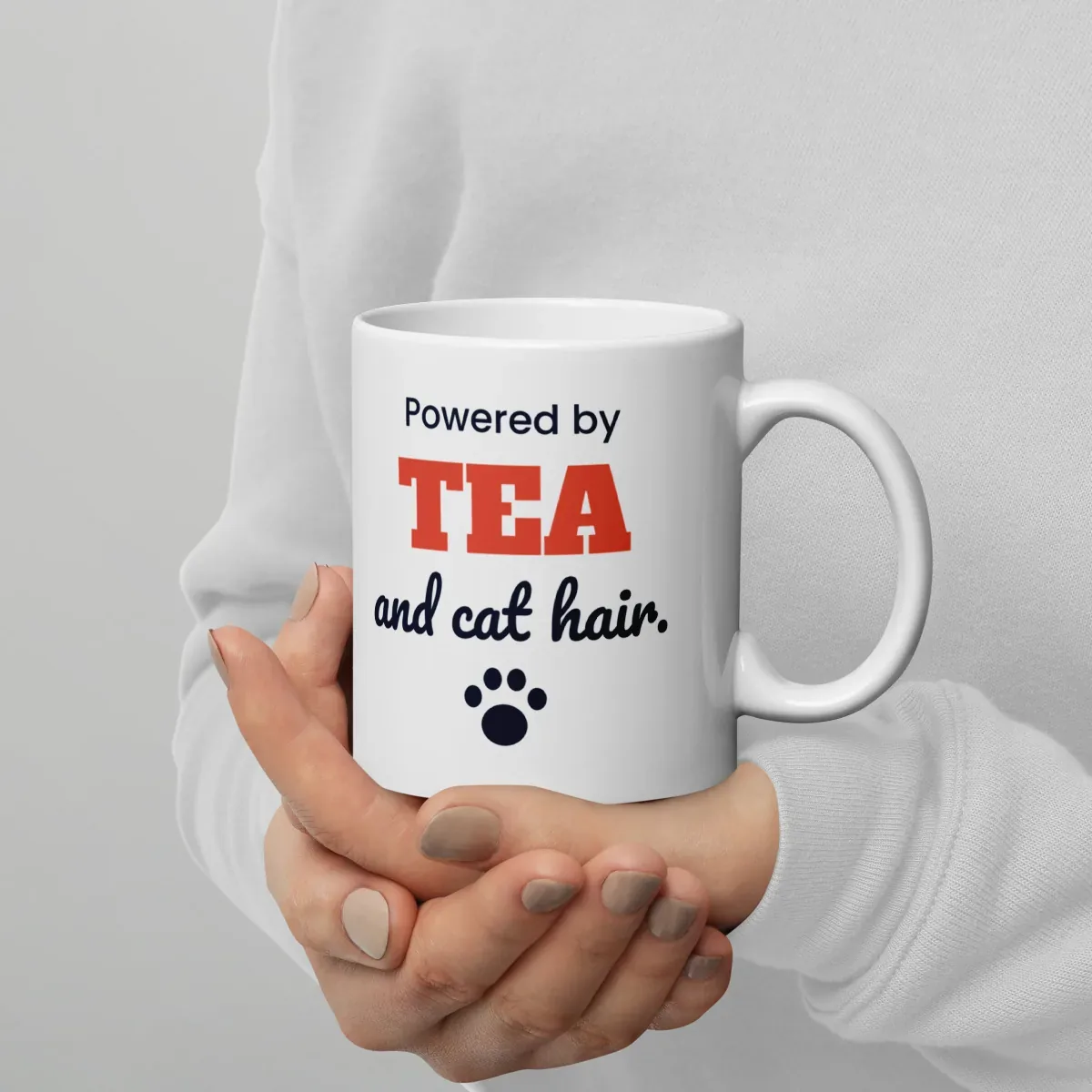 Powered by tea and cat hair — 11oz mug: In hand