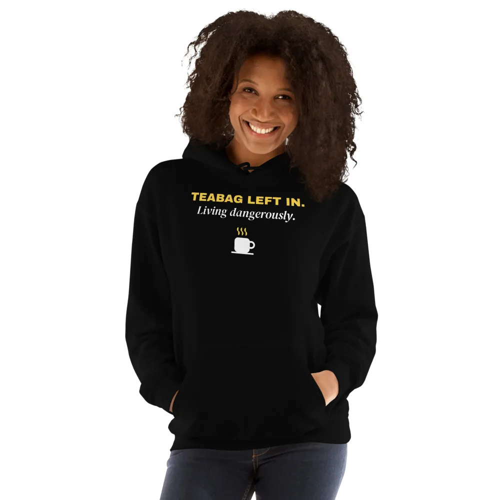 Teabag left in. Living dangerously. — black unisex hoodie: On model, another person
